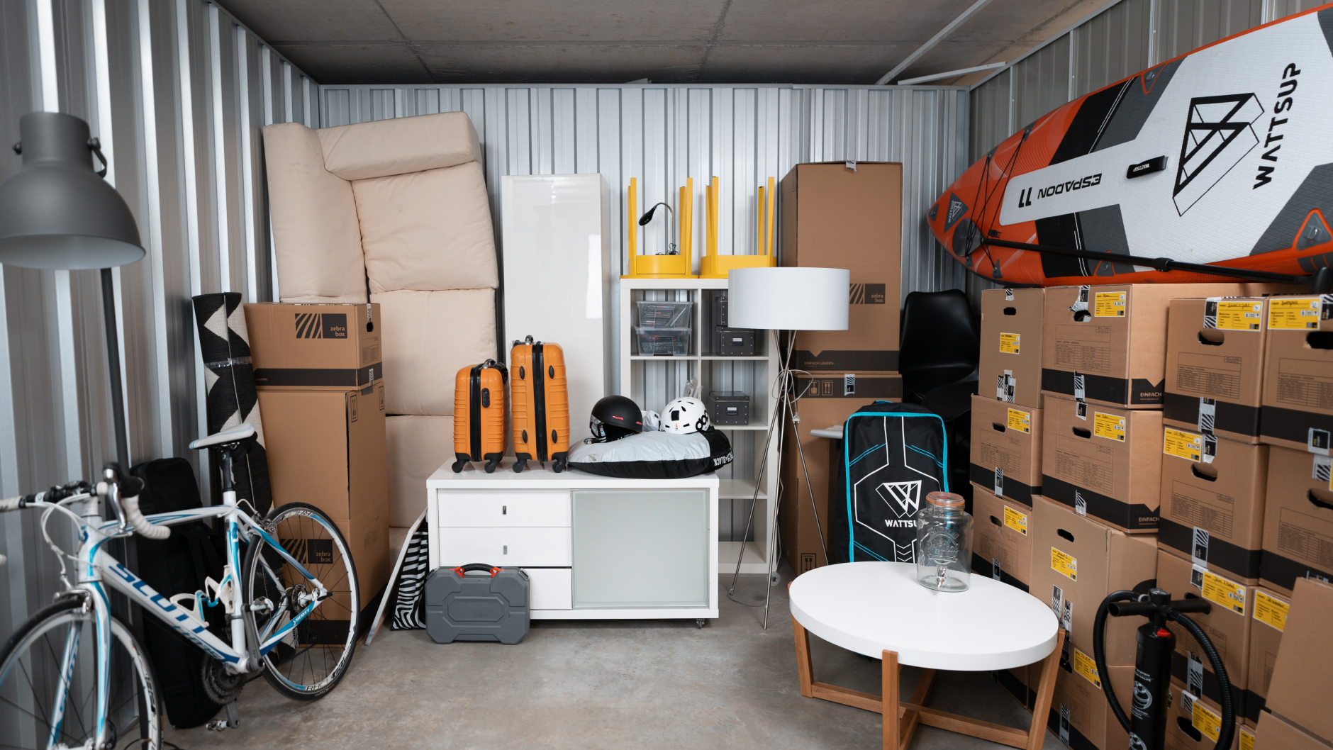 A Zebrabox storage unit filled with household goods, moving boxes and sports equipment.